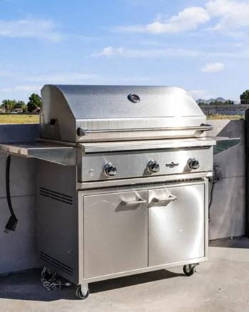 a stainless steel grill on a patio